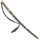 The 39 3/10” overall sword slides smoothly into a black wooden scabbard with polished brass accents
