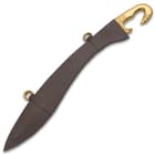 The 25 1/4” overall Falcata sword reproduction slides securely into a genuine leather scabbard with brass hanging rings