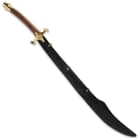 The shamshir is shown inside a dark leather scabbard, uniquely shaped for the curve of the blade. 