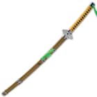 The 39” overall katana slides smoothly into a yellow wooden scabbard, which has metal accents and green cord-wrap