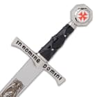 The 11” overall replica miniature sword has a metal handle with a silver, nickel-plated finish and a red cross on the pommel