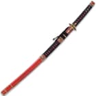 The katana comes in a red, wooden scabbard, which also hides an 8 1/4” overall, unsharpened stainless steel dagger