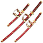 The red wooden scabbards have gold-painted artwork, and each has a white cord and faux leather sword hanger