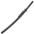 Death dealer katana in a black lacquered wooden scabbard with a black and yellow cord-wrap accent
