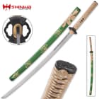The 40 9/10” overall katana slides smoothly into a green lacquered scabbard with gold spatter-print accents and cord-wrap