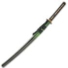 The 41” overall katana slides securely into a black lacquered wooden scabbard, which has a green splatter-print accent