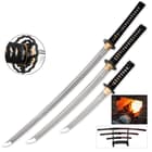 The katana, wakizashi, and tanto of the set laid side-by-side with detailed view of the black tsuba and showing swords on wooden display. 