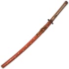 The 41 3/10” overall katana slides smoothly into its brown wooden scabbard, accented with gold-painted starbursts