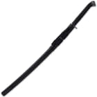 The scabbard is wooden with a semi-gloss black finish and features black faux leather wrapping and cotton cord