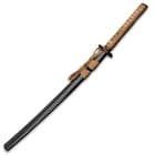 The 30 3/4” overall wakizashi slides smoothly into a black, lacquered wooden scabbard with brown cord-wrap accent