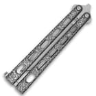 Detailed view of the skeletonized dark epoxy powder-coated handles of the butterfly knife.