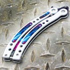 The white handles are of stainless steel with resin inserts that have the purple cosmic design to match the blade