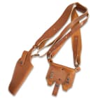 The pistol holster is expertly crafted of premium leather with a snap strap closure and features an embossed US medallion