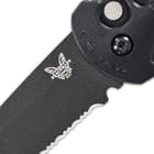 The sharp 3 3/5”, cobalt black CPM-D2 steel, drop point blade is partially serrated and has a 60-62 HRC