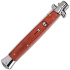 Closed wood handle stilleto pocket knife with button trigger and mirror polished accents.
