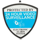 A tough plastic construction with vivid, weather-resistant artwork that states, “Protected By 24 Hour Video Surveillance; Electronic Alarm System”