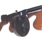 The authentic size and weight of the original gun, it features a 50-round removable drum and working bolt action