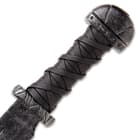 The guard and pommel are made of heavy-duty steel and the grip is wrapped in leather in an overlaid, knotted pattern