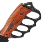 Upclose view of the matte black knuckle buster grip with pakkawood handle scales.
