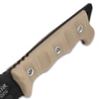 The ridged, handle scales are of tan TPU, secured with stainless steel inserts, and the tang extends into a lanyard hole