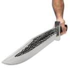 The massive 14 1/4”x 3” stainless steel blade has been hammer-forged for a rough texture and it has a deep blood groove