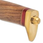 The handle is crafted of natural wood with bands of red wood, separated by brass spacers and it has a brass pommel