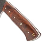 Detailed view of the wooden handle scales, secured to the tang with brass pins with a brass lanyard hole on the end.