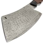 It has a hefty 8 1/4”, full-tang Damascus steel blade that’s made to chop through any and everything, including bone