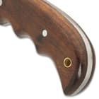 The brown wooden handle scales are secured to the tang by stainless steel pins and the handle features a lanyard hol