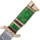 The handle is crafted of green wood, accented with white bone and black wood bands, separated by brass spacers