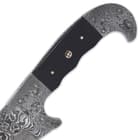 The full-tang, fileworked 12 1/2” Damascus steel blade has a trailing, modified clip point with a penetrating point