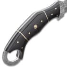 Detailed view of the black aged Micarta handle scales that are secured with stainless steel pins and has a rosette accent.