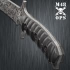 The machete has a textured reinforced impact-resistant handle.