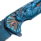 Side view of the knife’s cast stainless steel handle with engraved Shogun artwork.
