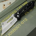 The black handle is crafted of stainless steel with skeletonized aluminum handles scales to reduce the overall weight