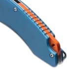 The handle scales are blue aluminum, secured to thumb-jimped liners and there is an orange backspacer with a lanyard hole