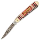 It has keenly sharp and resilient 440 stainless steel clip and spey blades, laser etched with Celtic-themed art and text