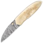 The knife has a razor-sharp, 3 1/4” Damascus steel sheepsfoot blade, which can be deployed by using a brass thumbstud