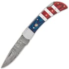 It has a razor-sharp, 3” Damascus steel blade that can be manually deployed using the nail nick