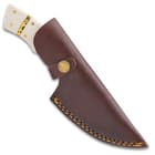 The Timber Wolf Snow Leopard Knife in its leather sheath