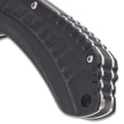 The handle scales are black G10 with deep ridges to give you a secure, slip-free grip and the handle has a lanyard hole