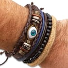 You get a natural jute, a wooden bead, a leather thong and a braided leather bracelet with an inner eye medallion