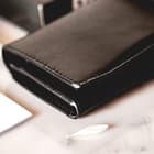 The wallet is made of faux leather and the interior is composed of an ABS shell for safe storage of the lighter fluid
