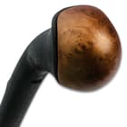 Zoomed view of the faux wood cap of the shillelagh. 