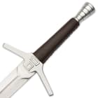 It has a grippy, dark leather-wrapped wooden handle and the hefty pommel is crafted of aluminum