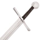 Detailed view of the brown grooved wooden grip and coordinating metal pommel and guard. 