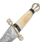  Closeup view of the carved bone handle with scalloped brass guard and pommel. 