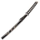 The wakizashi has a black cord wrapped handle and dragon design on the scabbard. 
