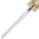 It has an 8 1/8” unsharpened, stainless steel blade with a black wooden handle, topped with an ornate, gold-toned pommel