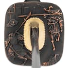 The hardwood handle is traditionally wrapped in faux rayskin and black cord and has an intricately detailed metal tsuba